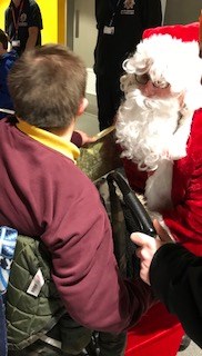 Image of Father Christmas meeting young people at the party