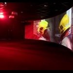 The immersive theatre with fire fighters entering a burring building.