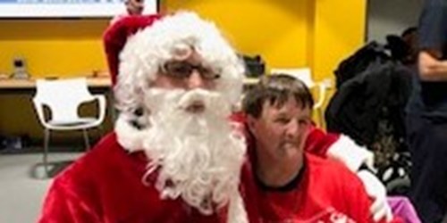 Image of Father Christmas with gest at the party